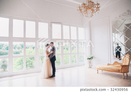 Beautiful bride and groom with veil over face Beautiful bride and groom with veil over face 32430956