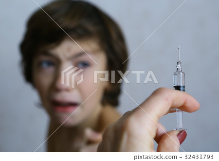 teenager boy afraid of syringe injection vaccination teenager boy afraid of syringe injection vaccination 32431793