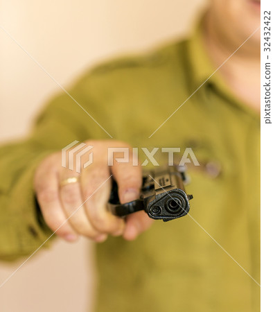 Man pointing gun at the target with one Hand 32432422
