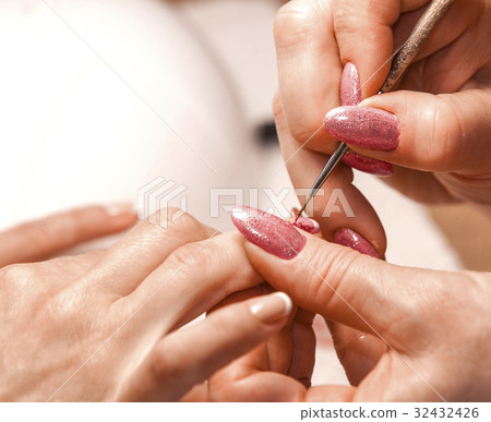 Master of manicure paints nails. 32432426