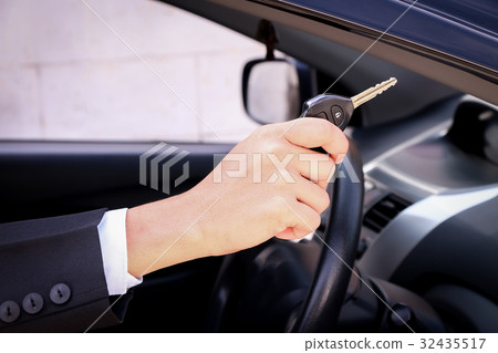 Business man smiling showing key 32435517