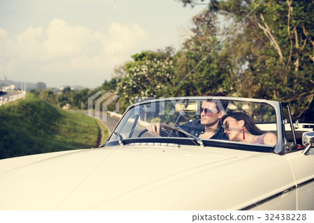 Couple Driving a Car Traveling on Road Trip Together Couple Driving a Car Traveling on Road Trip Together 32438228