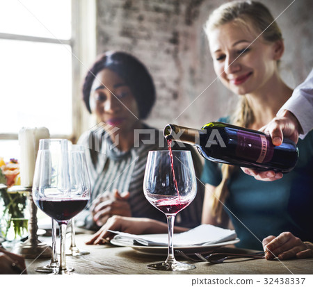 Restaurant Staff Poring Serving Red Wine to Customers Restaurant Staff Poring Serving Red Wine to Customers 32438337