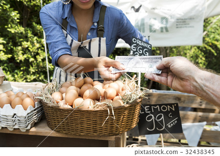 Woman Selling Fresh Chicken Eggs at Local Farmer Market 32438345