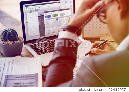 Businessman Working Writing Graph Bar On A Wooden Table 32439057