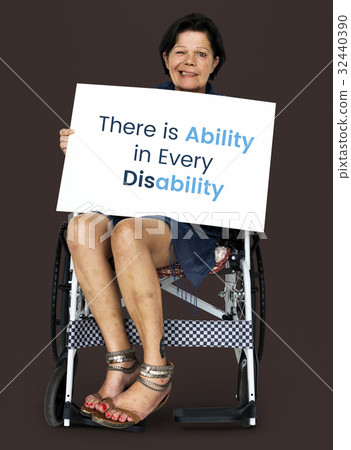 Senior adult woman on wheelchair holding motivation banner Senior adult woman on wheelchair holding motivation banner 32440390