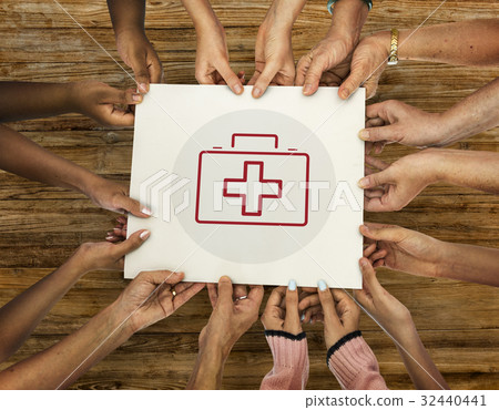 Diverse hands hold healthcare concept card Diverse hands hold healthcare concept card 32440441