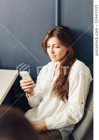 Fashionable Young Woman in white using phone 32443335