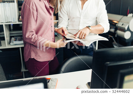 Two students reading book about desidn together 32444602