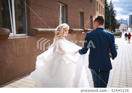 Young wedding couple walking together 32445226