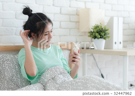 Young Asian woman taking selfie photo in bedroom 32447962
