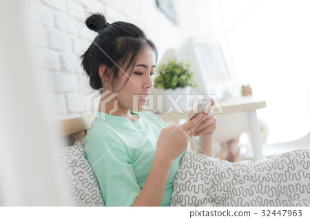 Young Asian woman taking selfie photo in bedroom 32447963