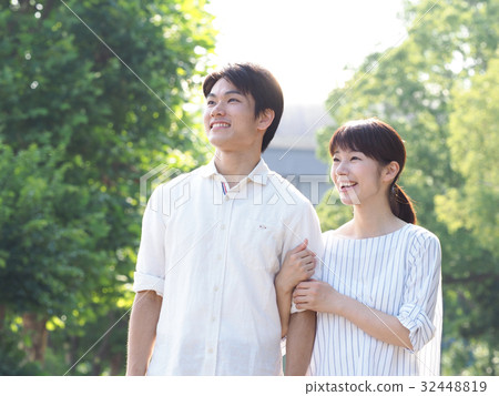A couple laughing with arms folded A couple laughing with arms folded 32448819