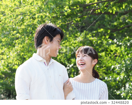 A couple laughing with arms folded A couple laughing with arms folded 32448820