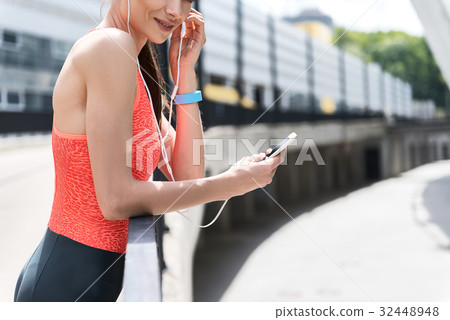 Excited sportswoman listening to song outdoor Excited sportswoman listening to song outdoor 32448948