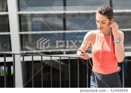Happy young woman listening to music after Happy young woman listening to music after 32448949
