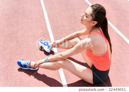Pretty sporty woman resting after running Pretty sporty woman resting after running 32449051