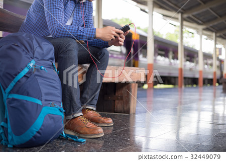man traveler with backpacker listening to music man traveler with backpacker listening to music 32449079