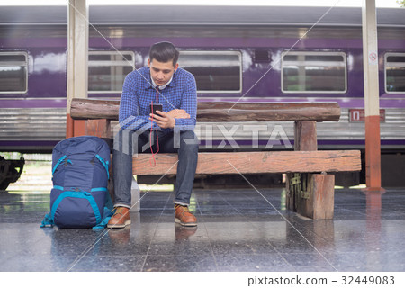 man traveler with backpacker listening to music man traveler with backpacker listening to music 32449083