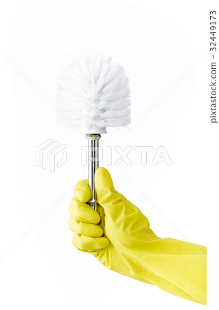 Hand in rubber yellow glove holds brush for toilet Hand in rubber yellow glove holds brush for toilet 32449173