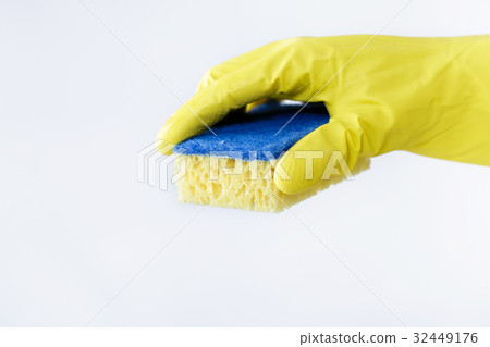 hand in rubber yellow glove holding sponge on hand in rubber yellow glove holding sponge on 32449176