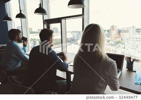 Youthful males and lady having coffee break while Youthful males and lady having coffee break while 32449477