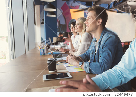 Happy youthful guy and girls communicating at work 32449478