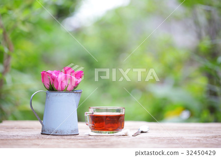 Red tea in glass with blue flower pot Red tea in glass with blue flower pot 32450429