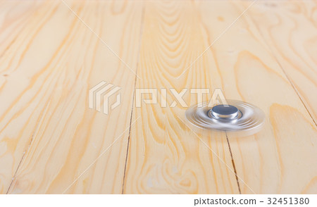 hand with spinner on table. hand with spinner on table. 32451380