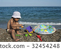 girl plays with toys on the beach 32454248