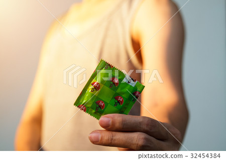 Man holding condom 32454384