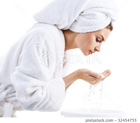 Young woman washing face with clean water. Young woman washing face with clean water. 32454755
