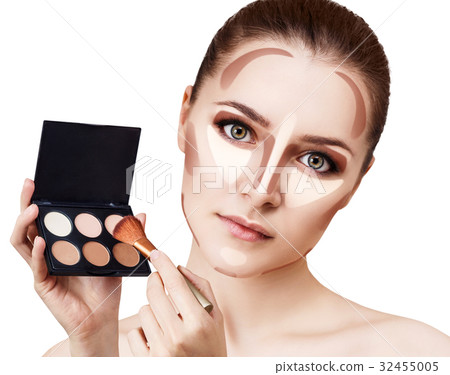 Young woman holding palette for contouring face. Young woman holding palette for contouring face. 32455005