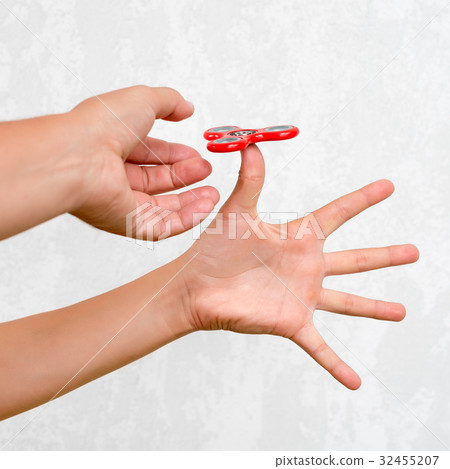 Fidget spinner. Red hand spinner, boys playing 32455207