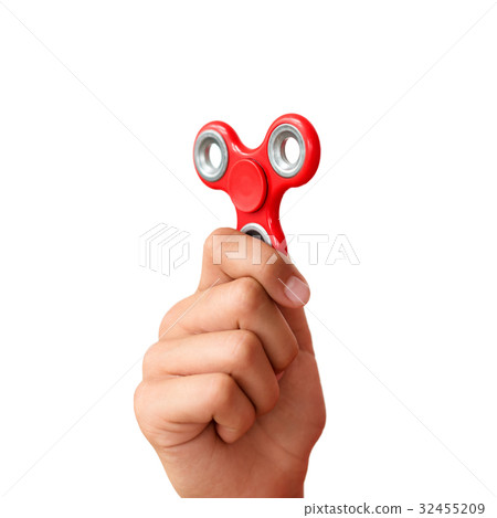 Red hand spinner. Boy playing a popular toy fidget 32455209