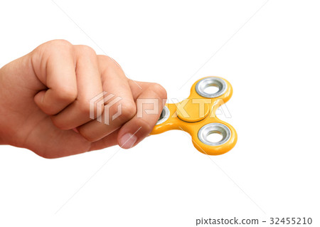 Yellow hand spinner. Boy playing a popular toy Yellow hand spinner. Boy playing a popular toy 32455210