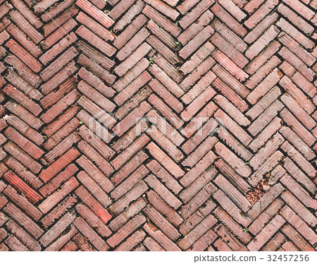 old brick pathway with herringbone pattern 32457256