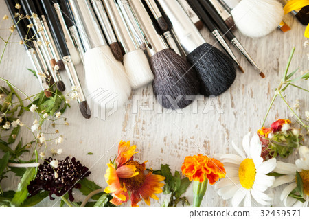 Make up accessories next to wild flowers Make up accessories next to wild flowers 32459571