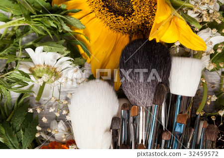 Make up accessories next to wild flowers Make up accessories next to wild flowers 32459572