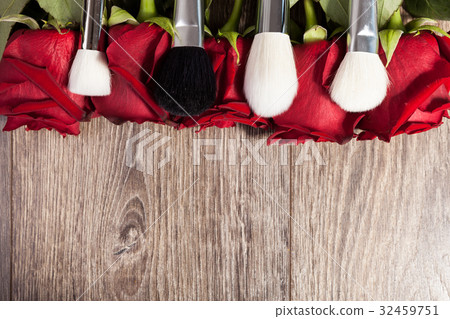 Conceptual image of make-up brushes next to roses Conceptual image of make-up brushes next to roses 32459751
