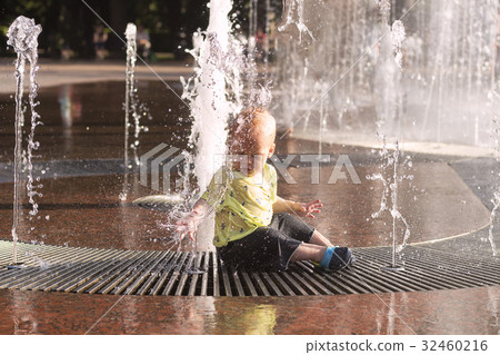 Cute toddler sitting in fountain. Awesome baby boy Cute toddler sitting in fountain. Awesome baby boy 32460216