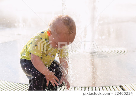 Cute little kid splashing in fountain. Adorable Cute little kid splashing in fountain. Adorable 32460234