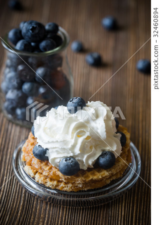 Waffle with whipped cream and blueberries 32460894