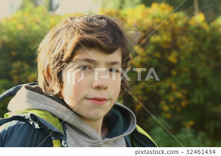boy close up portrait in autumn city park 32461434