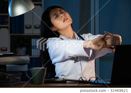 Photo of a tired young female doctor stretch 32469621