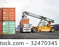 Forklift truck lifting cargo container in yard 32470345