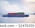 Cargo ship sailing away against sunrise 32470350