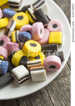 Mixed liquorice candies on plate. Mixed liquorice candies on plate. 32473003