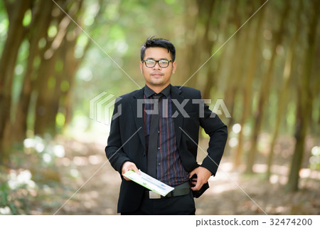 Plant researchers are checking latex rubber trees. 32474200
