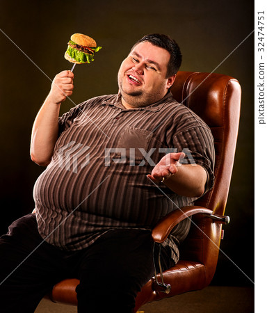 Fat man eating fast food hamberger. Breakfast for Fat man eating fast food hamberger. Breakfast for 32474751